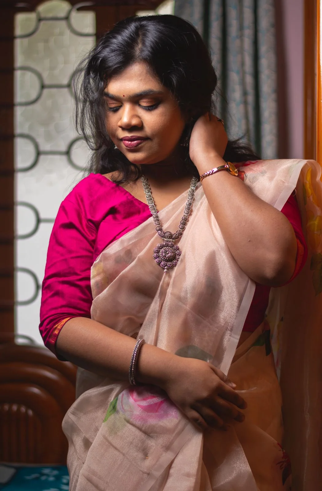 Magenta sari blouse with three-quarter sleeves and gold-tone cuff trim, front view.