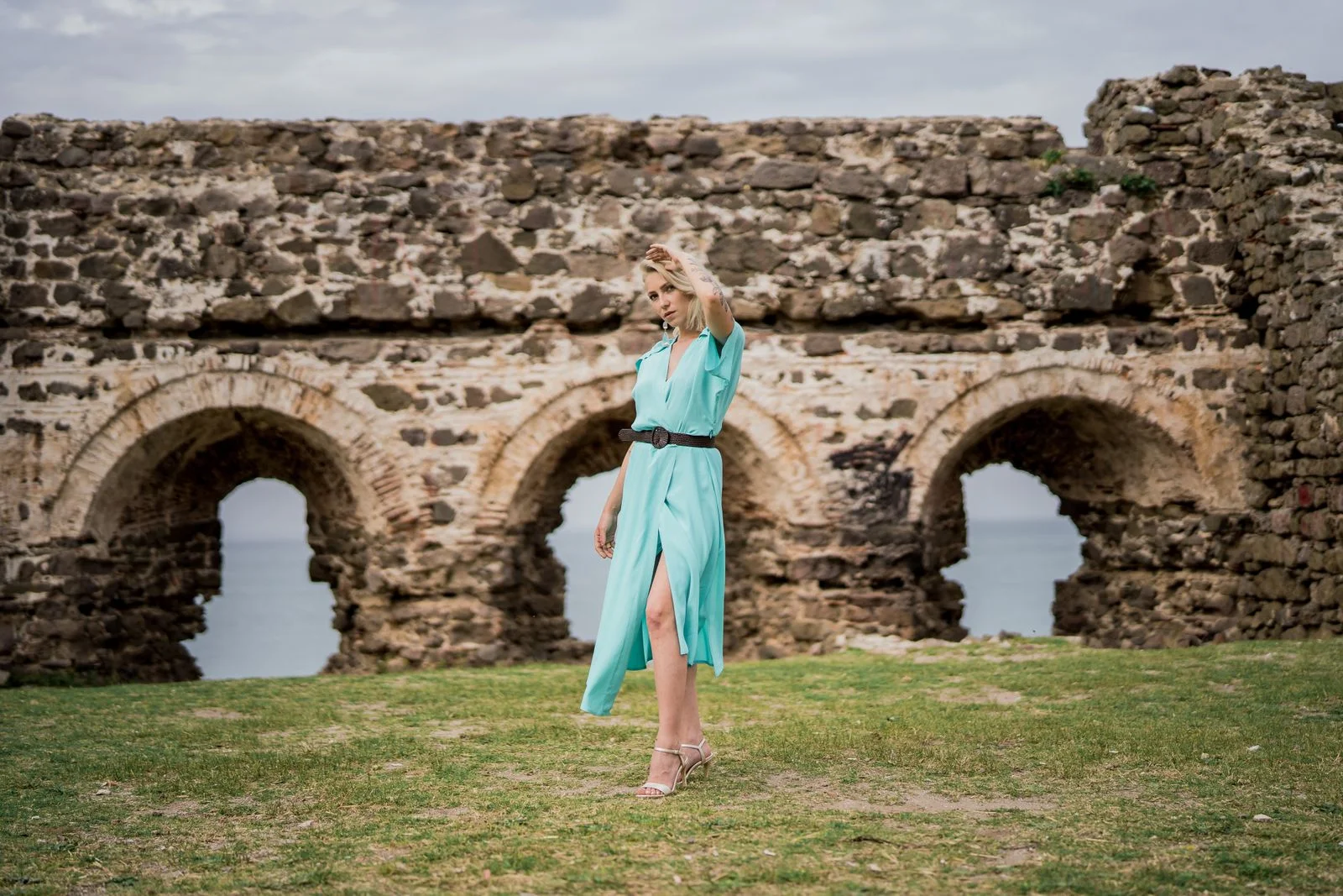 Plain light aqua/mint midi wrap dress photographed by stone ruins.
