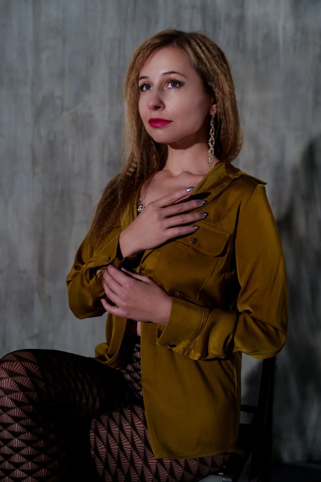 Mustard/olive button-front blouse with chest pockets, shown in a grey studio.